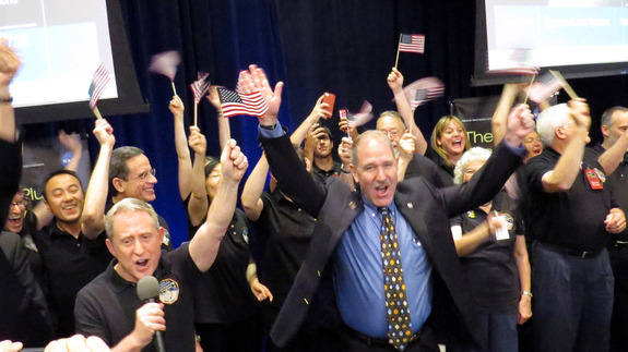 Members of the National Aeronautics and Space Administration celebrate in Laurel, Maryland, on July 14, 2015, as NASA's New Horizons spacecraft made the closest approach to Pluto to send photos and data back to Earth. (Kyodo) ==Kyodo