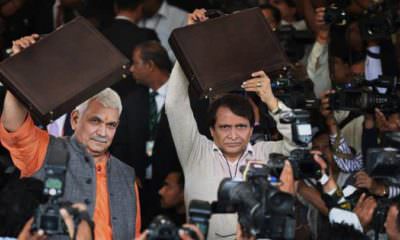 New Delhi: Union Minister for Railways, Suresh Prabhu along with MOS Manoj Sinha arrive at Parliament for presenting the Railway Budget 2016-17, in New Delhi on Thursday. PTI Photo by Vijay Verma