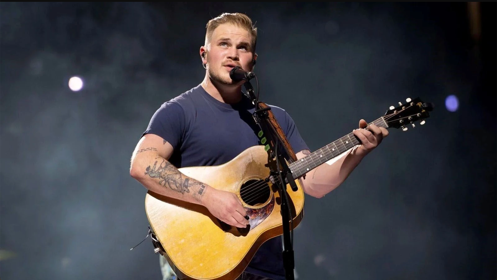 Zach Bryan Responds to ICE Lyric Backlash “I Love This Country More Than Anything” Bad News Immigration Christi Noem DHS